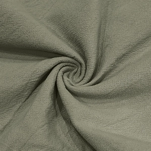 Detailed macro view of olive green linen fabric texture with soft woven pattern and drape
