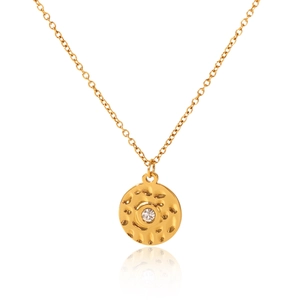 Macro detail of 18K gold-plated round pendant with hammered texture and sparkling star diamond