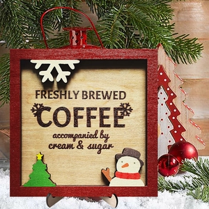 Close-up of wooden Christmas coffee plaque with 3D snowman and snowflake decor