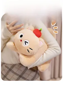 Detailed view of soft beige cat plush toy with red apple being held by person