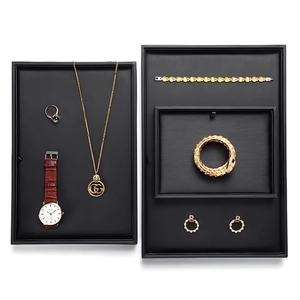 Set of minimalist black jewelry display trays for rings and necklaces on white background