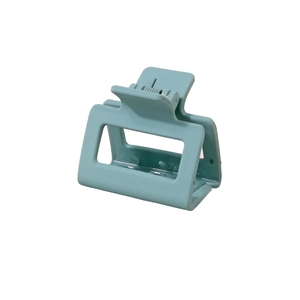 Detailed view of light blue square hollow hair claw clip with a matte finish on white