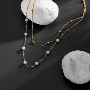 Elegant double layered stainless steel necklace with gold beads and white pearls