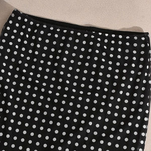 Close-up of semi-transparent mesh fabric with classic black and white polka dot pattern