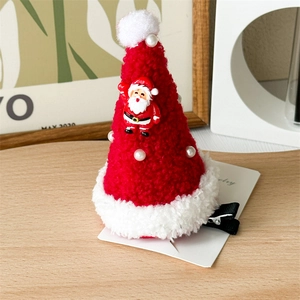 Detail of red and white velvet Christmas hat hair clip with Santa Claus and faux pearls