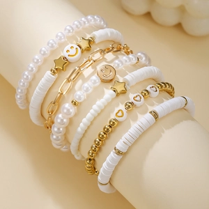 Detail of bohemian multilayer beaded bracelet set with smiley face and pink pearls