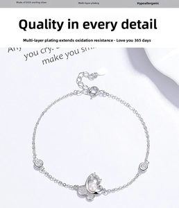 Detail of s925 silver butterfly bracelet with pearls and sparkling zircon stones