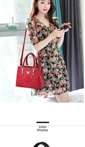 Close-up of red bag with intricate ethnic floral embroidery and metal logo hardware