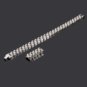 Polished silver titanium steel watchband bracelet with extra link on dark background