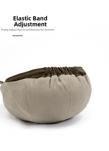 Detail of adjustable elastic back strap on khaki and brown two-tone canvas newsboy hat