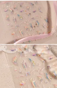 Macro detail of TL-52 iridescent butterfly nail stickers with 3D gold and pearl accents