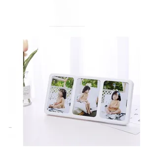 White triple folding photo frame featuring three portrait windows on a minimalist desk