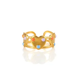 Detail of adjustable gold ring with colorful enamel heart beads on a white background