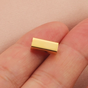 Minimalist gold hollow rectangle titanium steel charm displayed on fingers