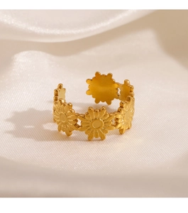 Macro view of golden daisy hollow ring with adjustable band on white silk fabric