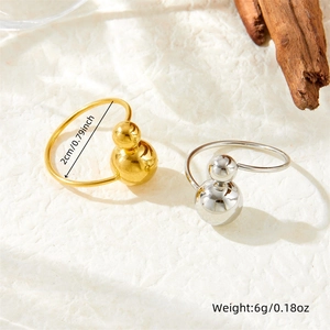 Minimalist gold and silver stainless steel rings with round beads on a natural background