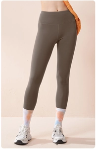 Detail of high-waist olive green yoga pants showing supportive compression fabric