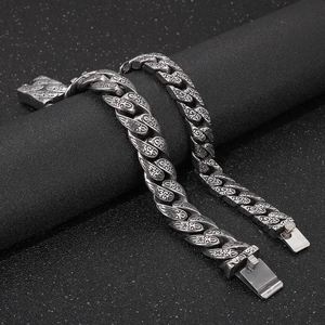 Vintage silver 304 stainless steel bracelet with baroque pattern on black pedestal