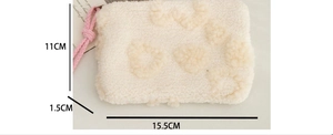 Detail view of cream plush heart pouch with dimensions showing 15.5cm length and soft texture