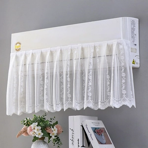 Close-up of white lace air conditioner cover with elegant floral embroidery and wave edges