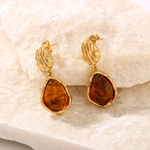 18K gold plated stainless steel resin earrings with textured oval drops on white stone