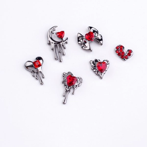 Close-up of gothic nail art charms with gunblack alloy and deep red heart zircons