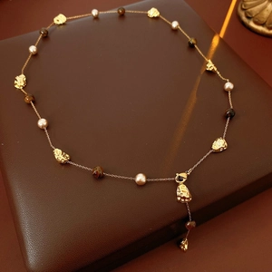 Retro Tiger Eye stone pendant necklace with gold chain and pearls on leather box