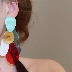 Detail view of colorful acrylic teardrop earrings with multi-color layered resin design