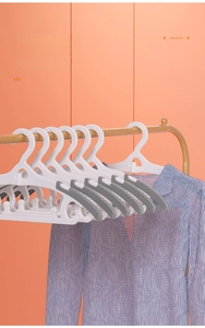 Detail of semi-circular non-slip children's hangers with grey silicone pads on gold rack