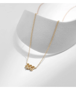 Detail of gold S925 silver necklace with interlocking circles and tiny center diamond