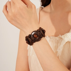Close-up of geometric coconut shell and wood bead stretch bracelet in bohemian retro style