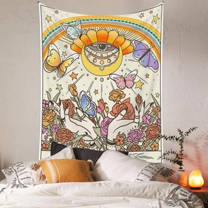 Bohemian tapestry with sun and butterfly pattern in a cozy bedroom scene