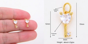 Detail view of heart-shaped key pendant with cubic zirconia inlay and size measurements