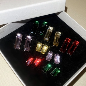 Macro shot of colorful rectangular cubic zirconia earrings on black velvet lining