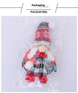 Christmas gnome plush toy with snowflake hat and tree accessory in packaging