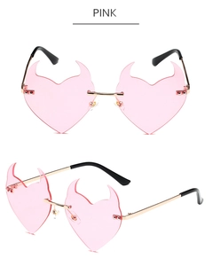 Pink heart-shaped devil sunglasses with gold metal temples and sharp horn lens details