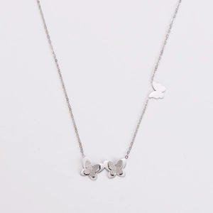 Detail of silver stainless steel necklace with frosted butterfly pendants and side butterfly charm