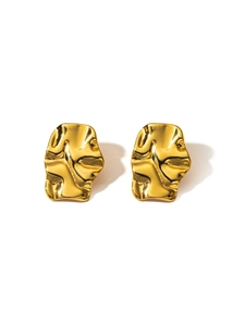 Detailed shot of gold-plated stainless steel earrings with irregular lava texture
