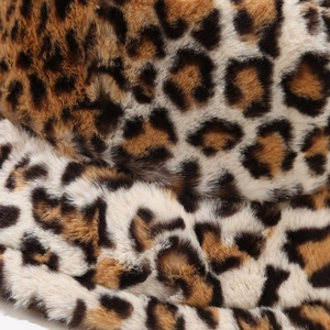 Detailed close-up of fluffy leopard print faux fur fabric showing soft texture and pattern