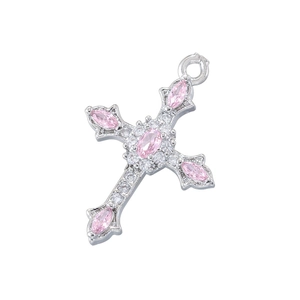 Detailed close-up of a silver cross pendant with pink gemstones and clear diamonds
