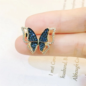 Elegant butterfly brooch with gold plating, blue sapphires and white cubic zirconia stones
