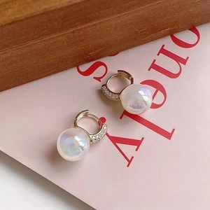 Macro shot of aura pearl hoop earrings with gold plating and cubic zirconia inlay