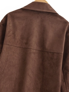 Detail of horizontal stitching and collar on the back of a dark brown suede blazer