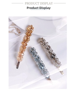 Detailed set of three handmade beaded flower hair clips in amber, blue, and gray colors