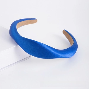 Detailed view of the thick navy blue satin headband with non-slip interior lining