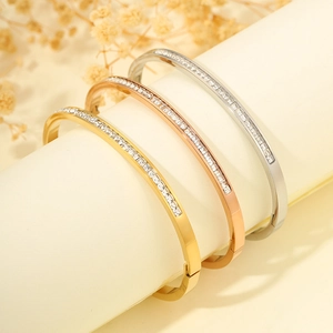 Three elegant titanium steel bracelets with cubic zirconia stones in gold and silver