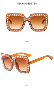 Detail view of square tea-colored sunglasses with sparkling glitter frame and crystals