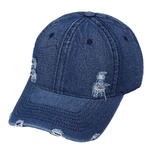 Classic dark blue washed denim baseball cap with vintage distressed holes and curved brim