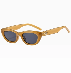 Detail of amber cat eye sunglasses with silver cross metal hinge on resin frame
