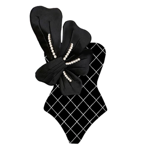 Detailed close-up of 3D satin bow with pearl accents and diamond lattice pattern